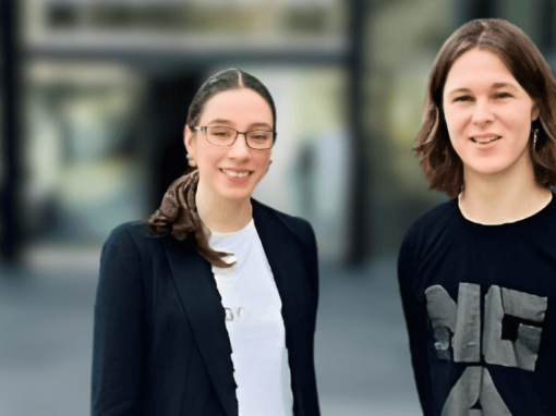 Two people outside a museum building.