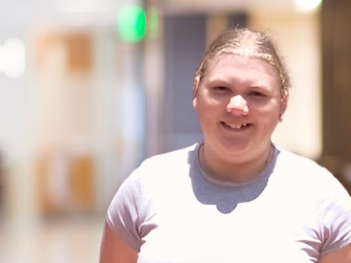 Woman standing inside an office.